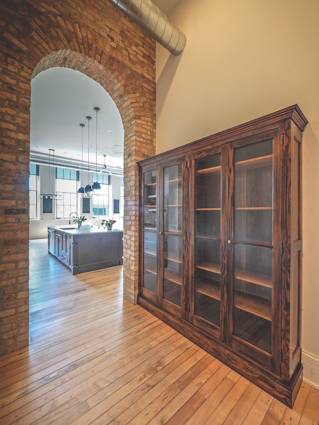 View to typical residential unit through a decorative brick arch.